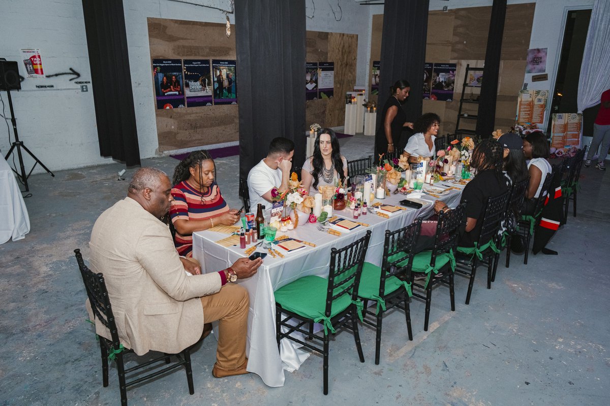 Wide shot of a long communal dining table at a hosted event