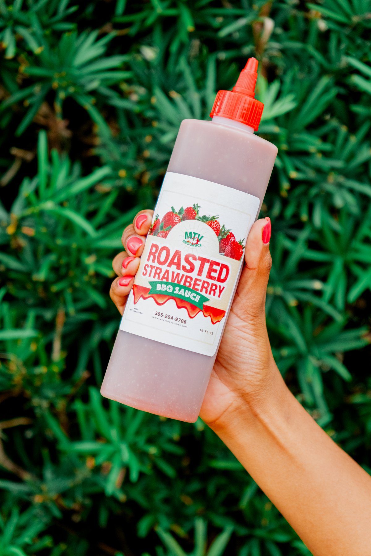 Bottled sauce photographed against foliage for packaging imagery