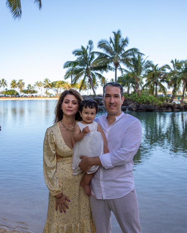 A family by a lagoon lined with palm trees