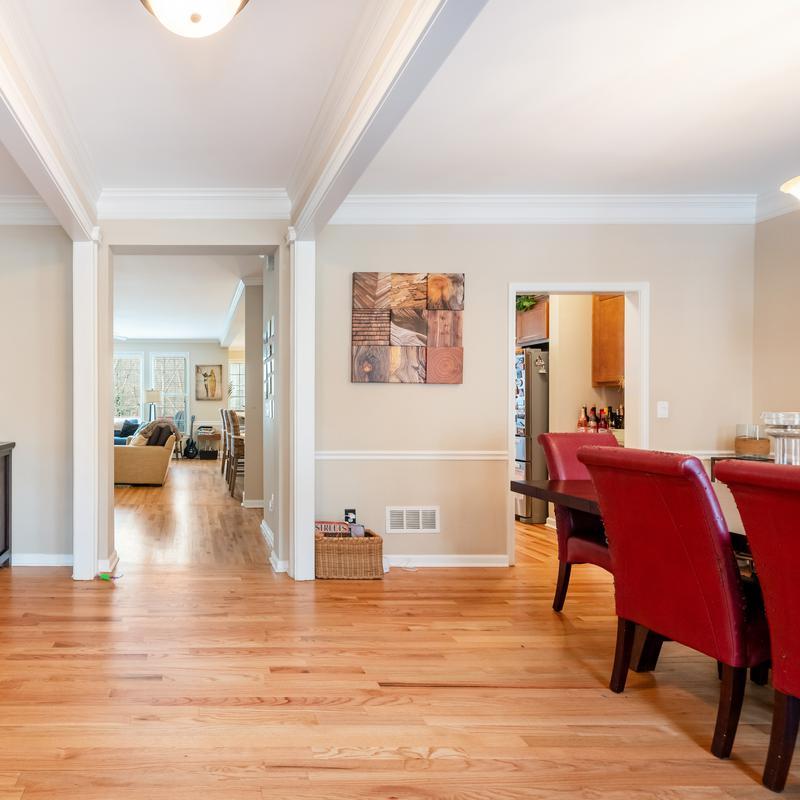 Living room with hardwood floors and a brick fireplace