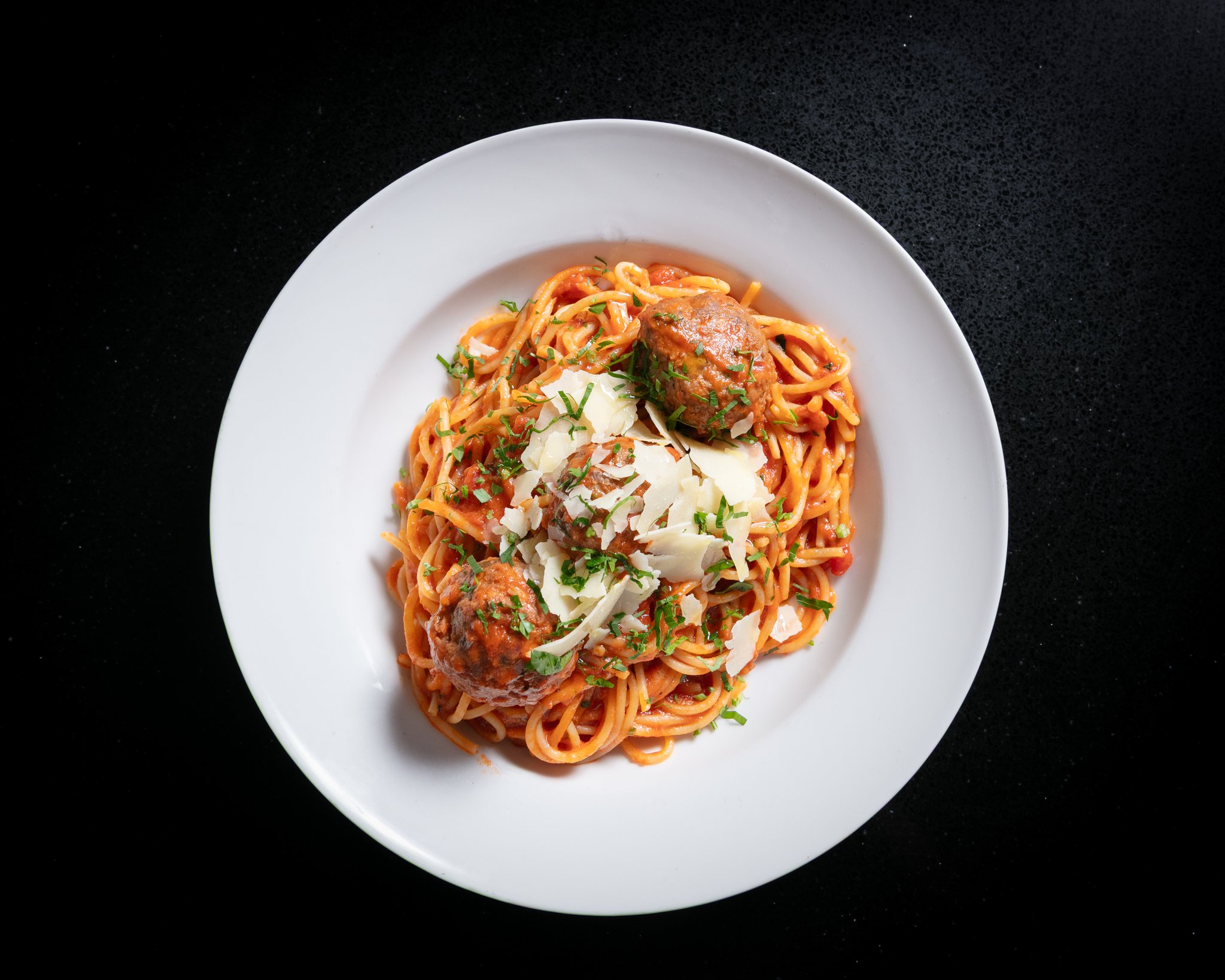 Spaghetti with beef meatballs in napoli sauce topped with parmesan